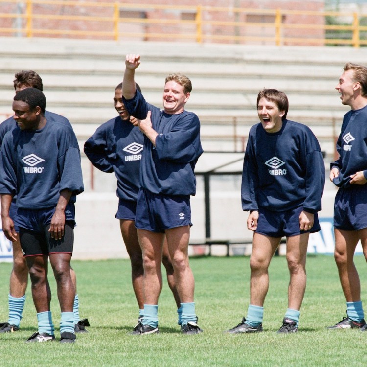 Group of soccer players in vintage Umbro training gear laughing and smiling during practice on a sunny field
